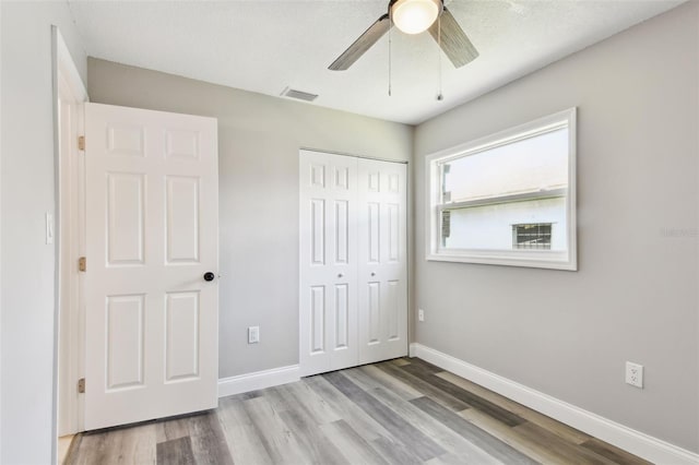 2902 Wheeler St, Bartow, FL 33830 - unfurnished bedroom with a closet, wood finished floors, and ceiling fan