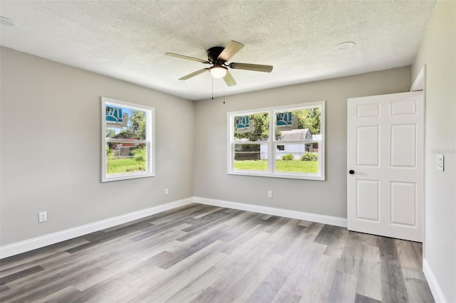 2902 Wheeler St, Bartow, FL 33830 - spare room featuring a textured ceiling, wood finished floors, plenty of natural light, and a ceiling fan