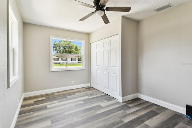 2902 Wheeler St, Bartow, FL 33830 - unfurnished bedroom featuring wood finished floors, a closet, and ceiling fan