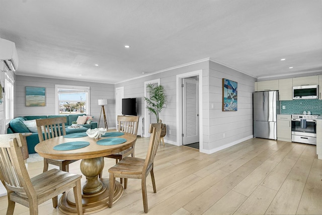 122 Coral Ave, Redington Shores, FL 33708 - dining area with ornamental molding, light wood-style flooring, an AC wall unit, recessed lighting, and wooden walls