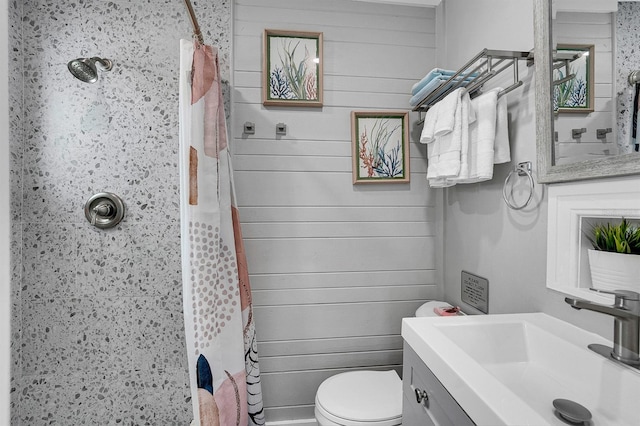122 Coral Ave, Redington Shores, FL 33708 - bathroom featuring a shower with shower curtain, vanity, and wood walls