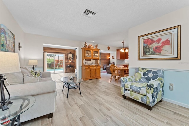 6289 107th Ave N, Pinellas Park, FL 33782 - living area featuring light wood-style floors and a textured ceiling