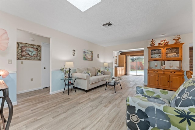 6289 107th Ave N, Pinellas Park, FL 33782 - living room featuring light wood finished floors and a textured ceiling