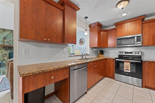6289 107th Ave N, Pinellas Park, FL 33782 - kitchen with stainless steel appliances, brown cabinets, light tile patterned floors, and a textured ceiling