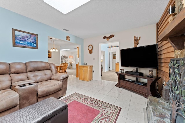 6289 107th Ave N, Pinellas Park, FL 33782 - living room with light tile patterned floors, a textured ceiling, and a skylight