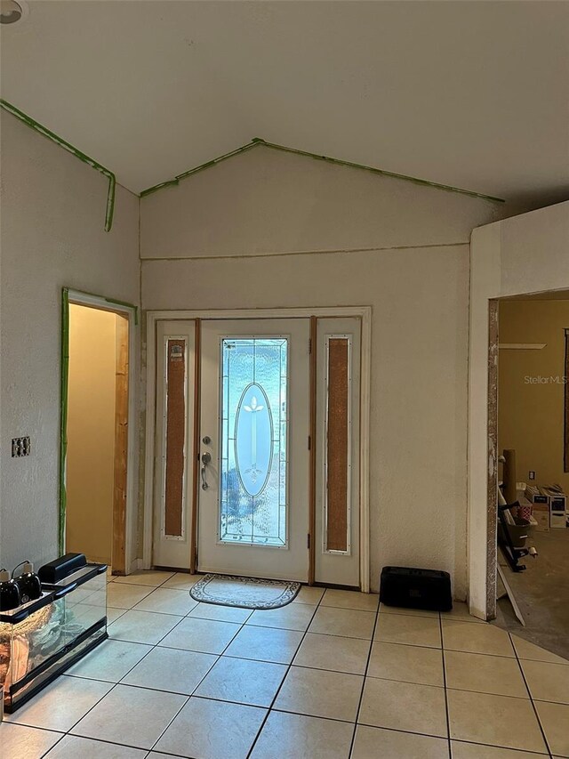 120 Henry St, Interlachen, FL 32148 - foyer entrance with light tile patterned flooring and vaulted ceiling