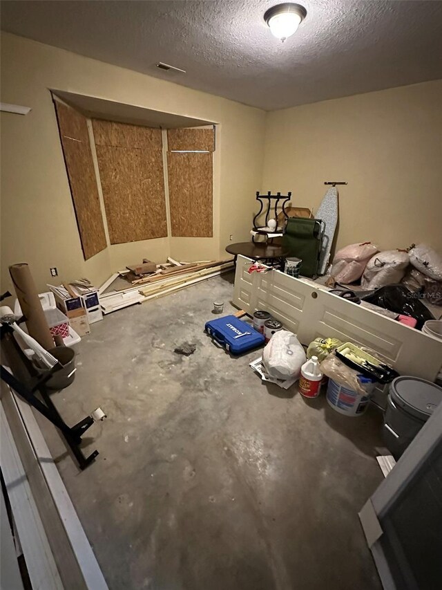 120 Henry St, Interlachen, FL 32148 - unfurnished bedroom with a textured ceiling and concrete flooring