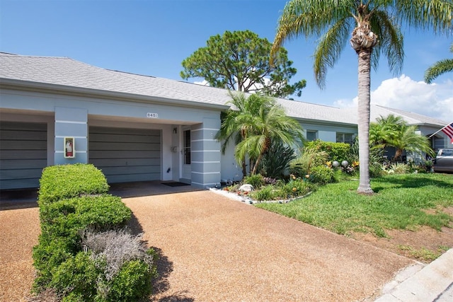 8451 Candlewood Rd Unit 8451, Seminole, FL 33777 - ranch-style house with driveway, an attached garage, and stucco siding