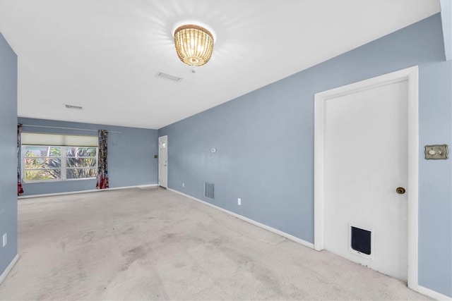 8451 Candlewood Rd Unit 8451, Seminole, FL 33777 - spare room featuring carpet and a chandelier
