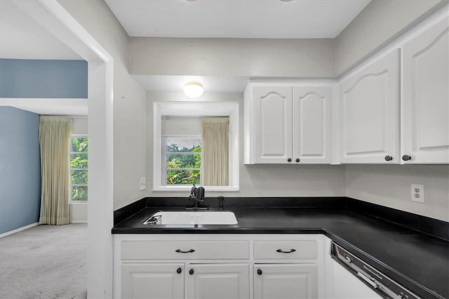 8451 Candlewood Rd Unit 8451, Seminole, FL 33777 - kitchen featuring dark countertops, white cabinets, carpet floors, and dishwasher