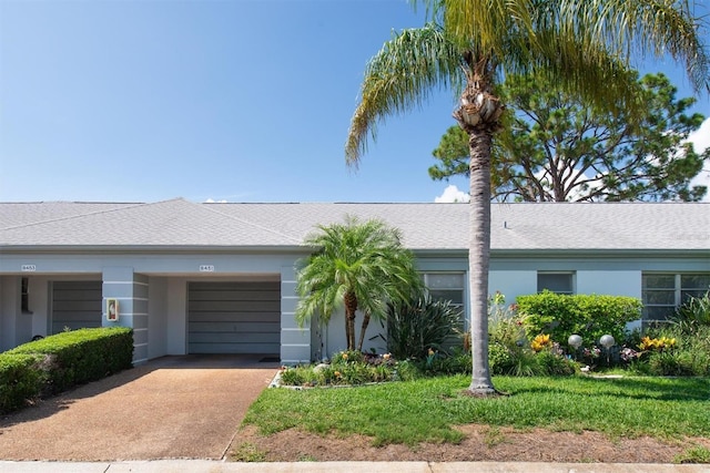 8451 Candlewood Rd Unit 8451, Seminole, FL 33777 - ranch-style home featuring an attached garage, driveway, and stucco siding