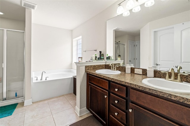 10909 Kirkwall Port Dr, Wimauma, FL 33598 - full bathroom featuring a stall shower, double vanity, a bath, and tile patterned floors