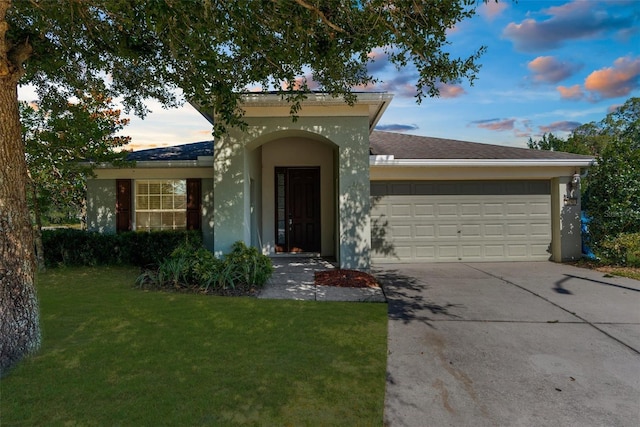 1280 Hill Flower Dr, Brooksville, FL 34604 - view of front of property featuring an attached garage, driveway, a front lawn, and stucco siding
