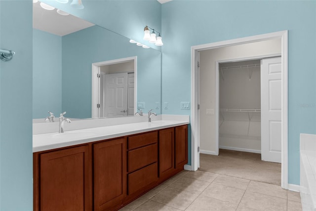 1280 Hill Flower Dr, Brooksville, FL 34604 - bathroom featuring double vanity, tile patterned floors, and a spacious closet