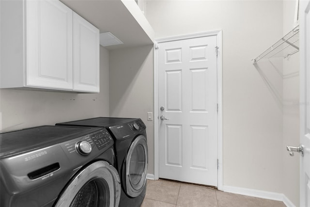 1280 Hill Flower Dr, Brooksville, FL 34604 - laundry room with washer and clothes dryer, cabinet space, and light tile patterned flooring