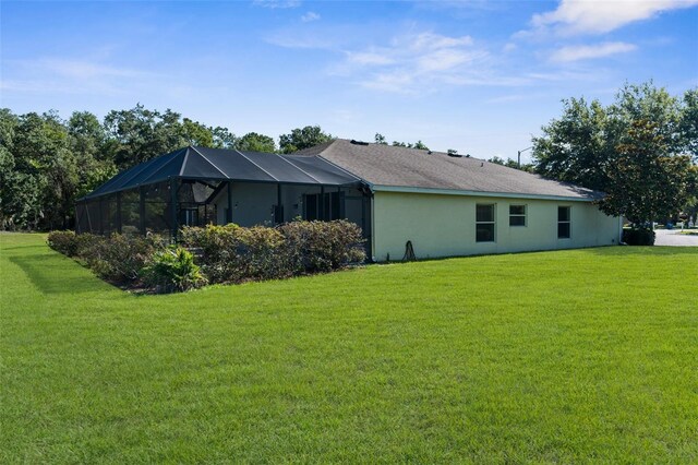 1280 Hill Flower Dr, Brooksville, FL 34604 - view of side of property featuring a yard, stucco siding, and glass enclosure