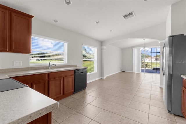 1280 Hill Flower Dr, Brooksville, FL 34604 - kitchen featuring black dishwasher, freestanding refrigerator, arched walkways, a chandelier, and brown cabinetry