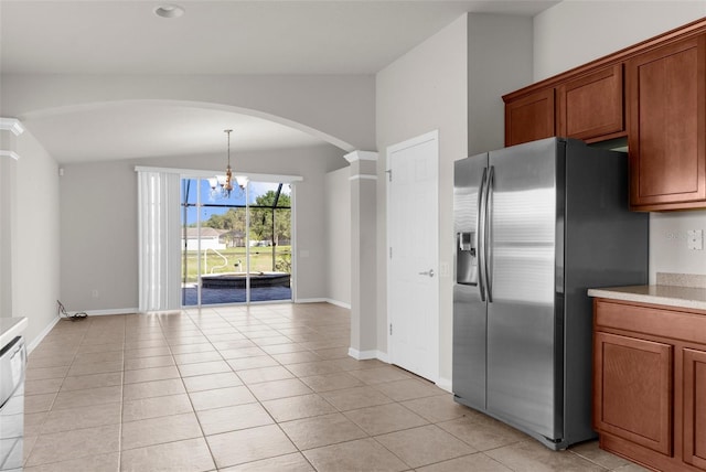 1280 Hill Flower Dr, Brooksville, FL 34604 - kitchen featuring stainless steel fridge with ice dispenser, vaulted ceiling, arched walkways, a chandelier, and light countertops