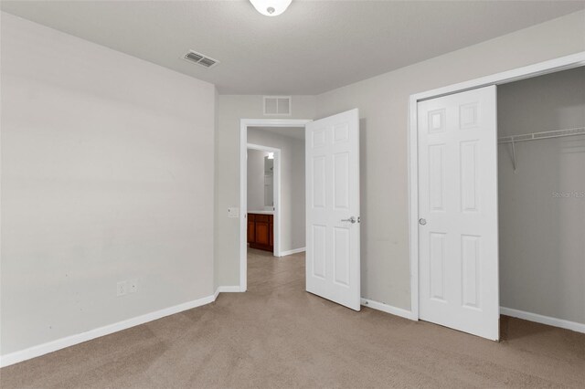 1280 Hill Flower Dr, Brooksville, FL 34604 - unfurnished bedroom with light colored carpet and a closet