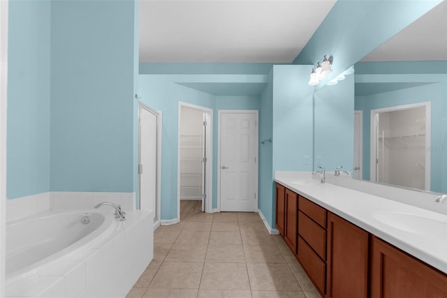 1280 Hill Flower Dr, Brooksville, FL 34604 - bathroom with a bath, double vanity, a walk in closet, and tile patterned flooring
