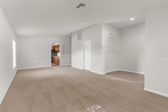 1280 Hill Flower Dr, Brooksville, FL 34604 - spare room featuring arched walkways, light colored carpet, recessed lighting, and lofted ceiling