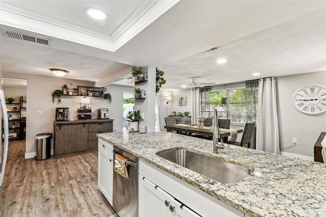 5744 Thrush Dr, New Port Richey, FL 34652 - kitchen with white cabinetry, ornamental molding, light wood-style floors, recessed lighting, and ceiling fan
