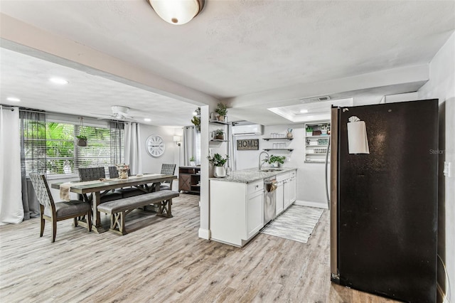 5744 Thrush Dr, New Port Richey, FL 34652 - kitchen with freestanding refrigerator, open shelves, white cabinetry, dishwasher, and light wood-style floors