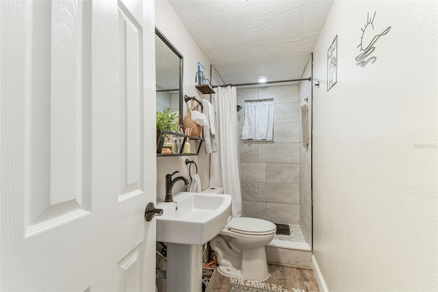 5744 Thrush Dr, New Port Richey, FL 34652 - bathroom with tiled shower, wood finished floors, and a textured ceiling