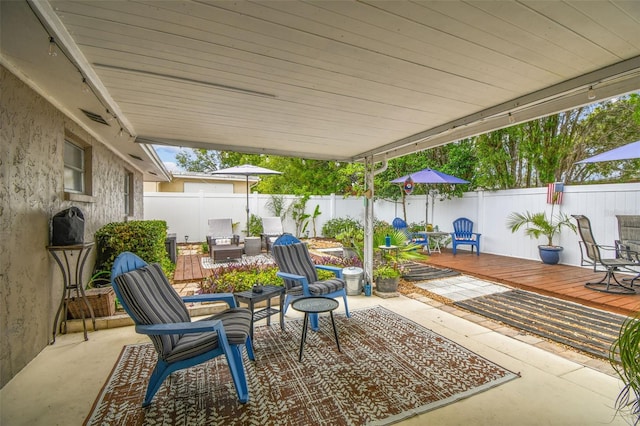 5744 Thrush Dr, New Port Richey, FL 34652 - fenced backyard featuring a deck, a patio, and outdoor dining area
