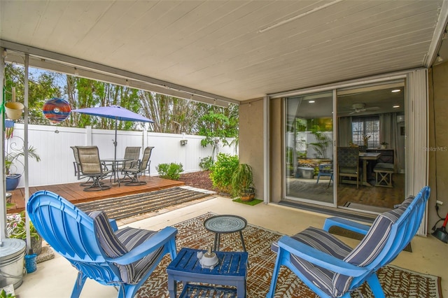 5744 Thrush Dr, New Port Richey, FL 34652 - fenced backyard with outdoor dining area and a wooden deck