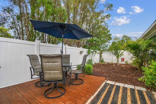 5744 Thrush Dr, New Port Richey, FL 34652 - wooden deck with outdoor dining space and a fenced backyard