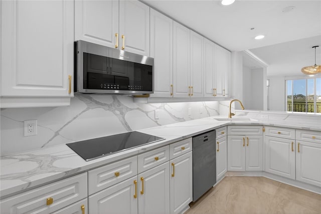 5430 Eagles Point Cir Unit 202, Sarasota, FL 34231 - kitchen featuring stainless steel appliances, backsplash, white cabinetry, light stone counters, and recessed lighting