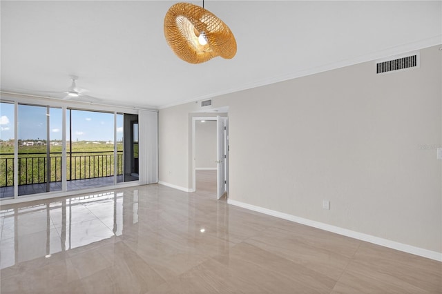 5430 Eagles Point Cir Unit 202, Sarasota, FL 34231 - spare room with a ceiling fan, ornamental molding, and marble tiled flooring