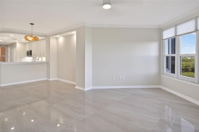 5430 Eagles Point Cir Unit 202, Sarasota, FL 34231 - unfurnished living room with plenty of natural light and ornamental molding