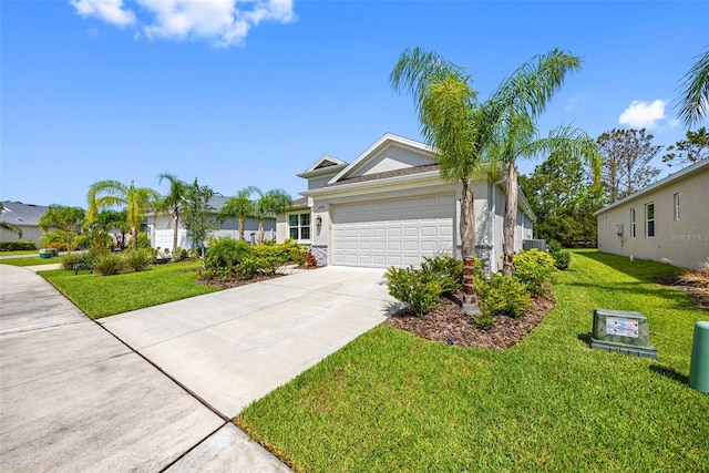 12739 Rainwashed Loop, Parrish, FL 34219 - ranch-style home with a garage, concrete driveway, a front yard, and stucco siding
