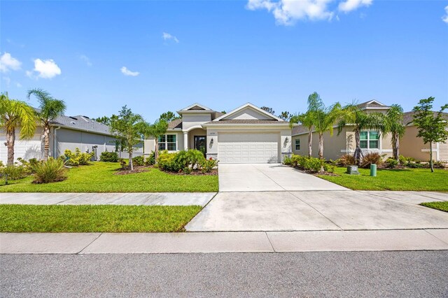 12739 Rainwashed Loop, Parrish, FL 34219 - ranch-style house with an attached garage, a front lawn, stucco siding, and driveway