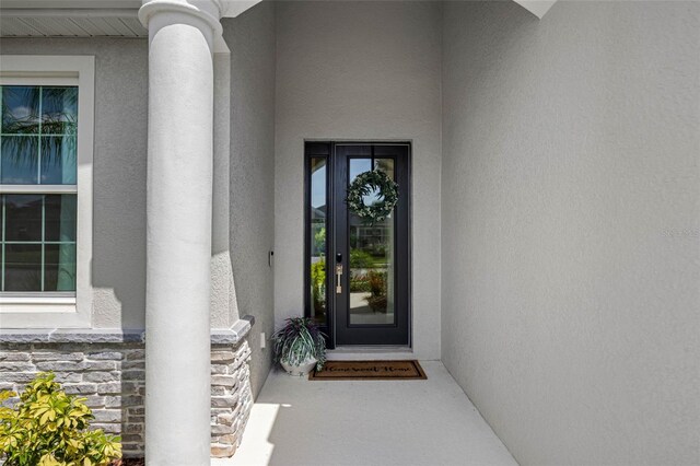 12739 Rainwashed Loop, Parrish, FL 34219 - doorway to property featuring stucco siding and stone siding