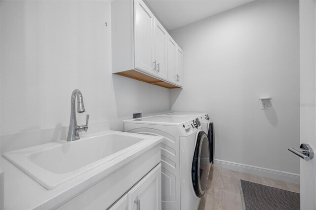 12739 Rainwashed Loop, Parrish, FL 34219 - washroom with washer and clothes dryer, cabinet space, and light tile patterned floors