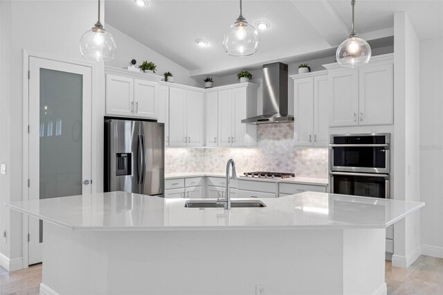 12739 Rainwashed Loop, Parrish, FL 34219 - kitchen featuring appliances with stainless steel finishes, wall chimney range hood, backsplash, white cabinets, and vaulted ceiling