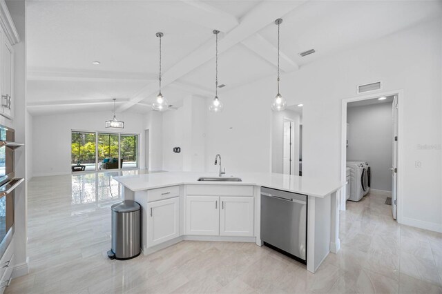 12739 Rainwashed Loop, Parrish, FL 34219 - kitchen with stainless steel dishwasher, independent washer and dryer, light countertops, open floor plan, and white cabinets