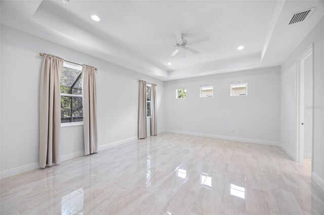 12739 Rainwashed Loop, Parrish, FL 34219 - empty room featuring a tray ceiling, a ceiling fan, healthy amount of natural light, and recessed lighting