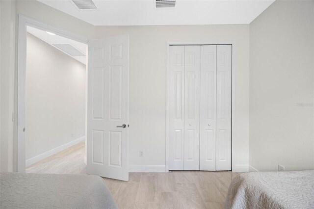 12739 Rainwashed Loop, Parrish, FL 34219 - unfurnished bedroom featuring a closet and light wood-style flooring