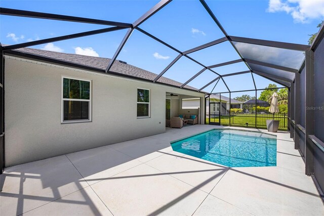 12739 Rainwashed Loop, Parrish, FL 34219 - swimming pool featuring a patio, an outdoor hangout area, a ceiling fan, and glass enclosure