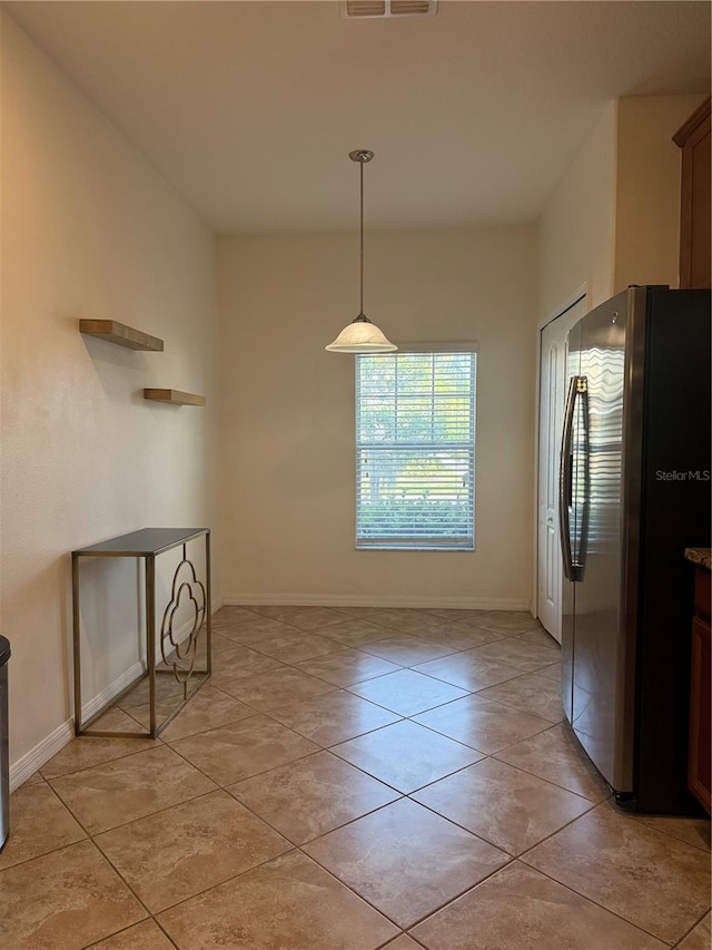 2411 Willimette Dr, Wesley Chapel, FL 33543 - unfurnished dining area with light tile patterned floors and baseboards