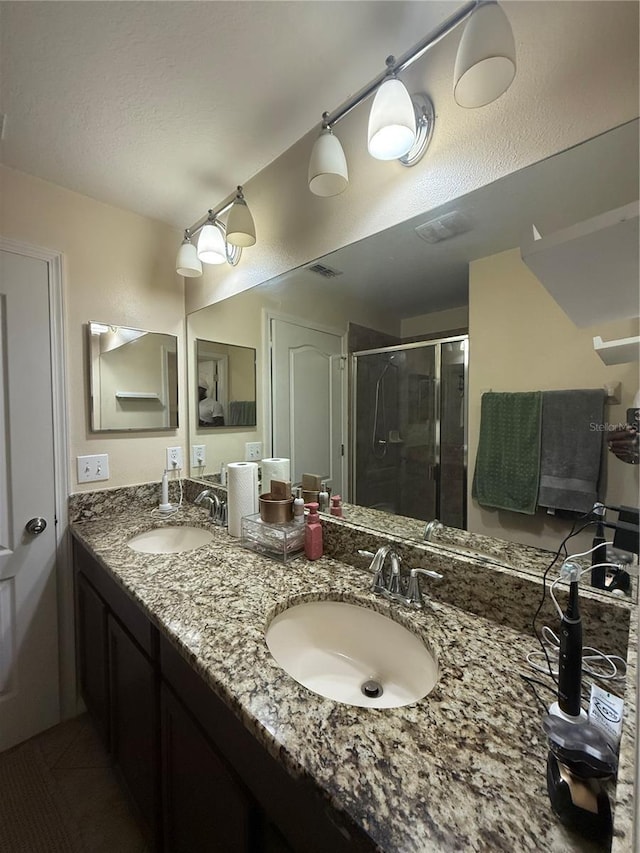 2411 Willimette Dr, Wesley Chapel, FL 33543 - bathroom with a stall shower, double vanity, and tile patterned floors