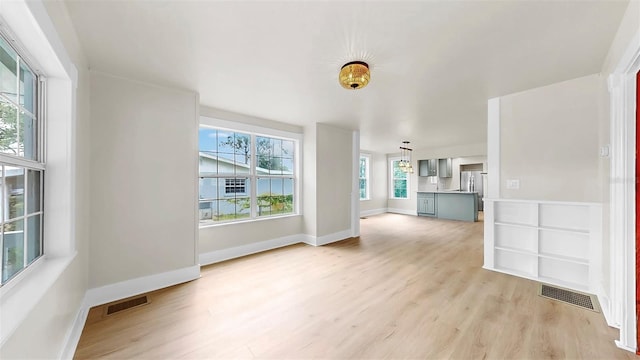 1005 45th St W, Bradenton, FL 34209 - unfurnished living room with light wood-style flooring