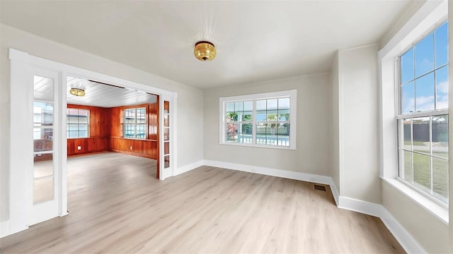 1005 45th St W, Bradenton, FL 34209 - unfurnished living room with light wood-style flooring and baseboards