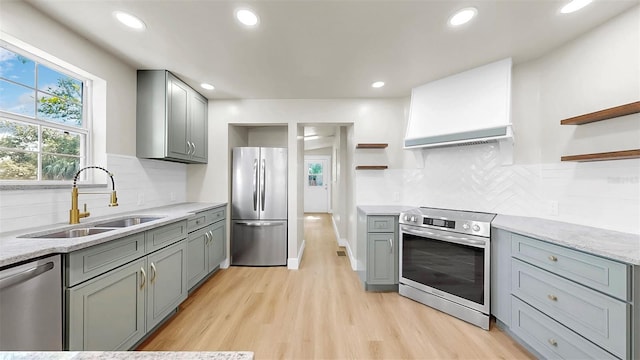 1005 45th St W, Bradenton, FL 34209 - kitchen with open shelves, stainless steel appliances, gray cabinetry, light wood-style floors, and recessed lighting