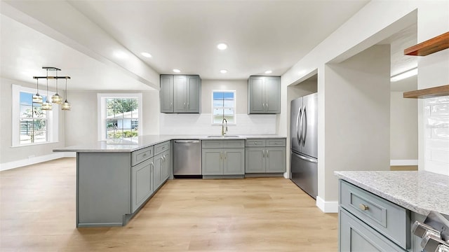1005 45th St W, Bradenton, FL 34209 - kitchen with stainless steel appliances, gray cabinets, a peninsula, decorative backsplash, and recessed lighting