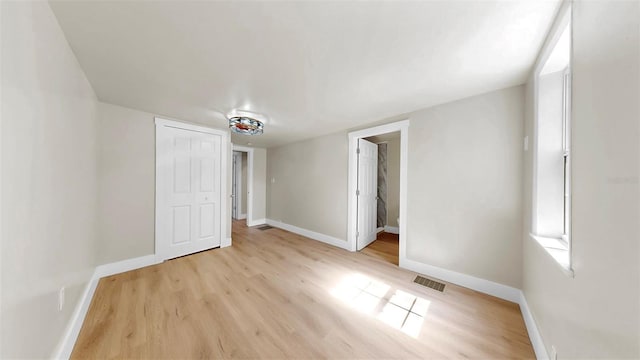 1005 45th St W, Bradenton, FL 34209 - unfurnished bedroom featuring baseboards and light wood-type flooring